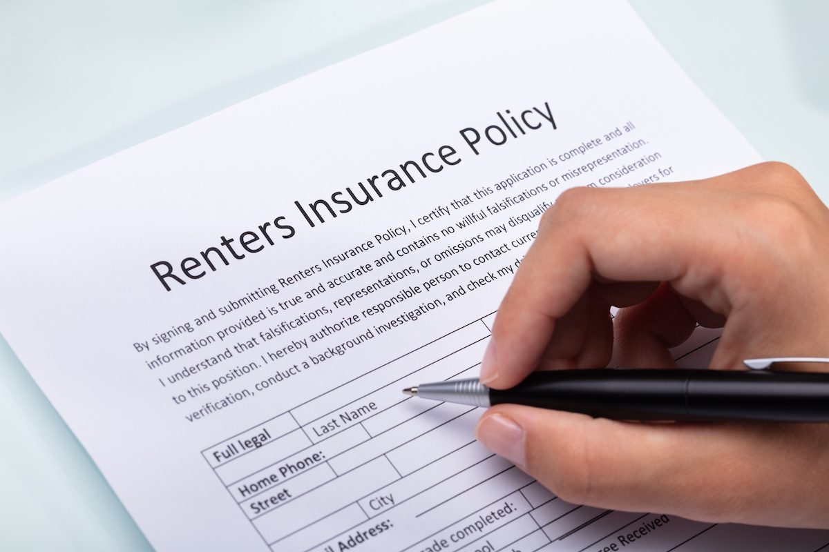 Renters Insurance Policy On A Table. Couple Filling Insurance ...